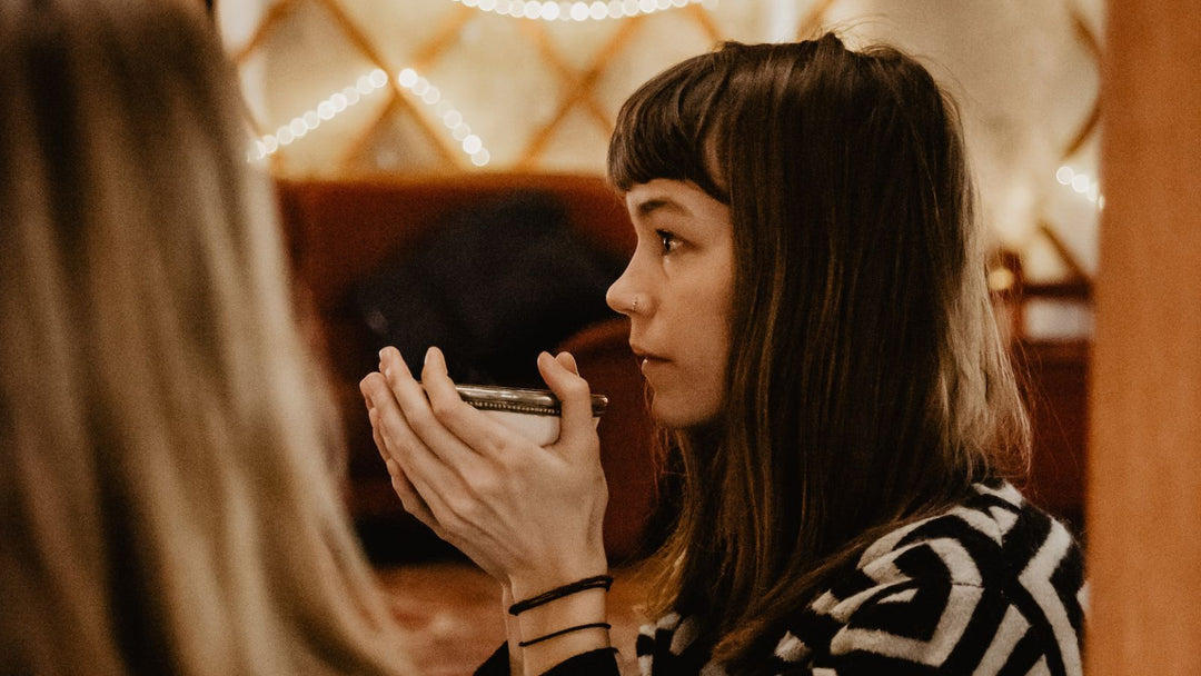 Young Woman drinking ceremonial cacao on a cacao ceremony